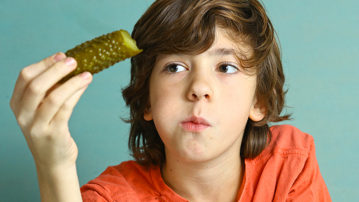 boy biting pickle